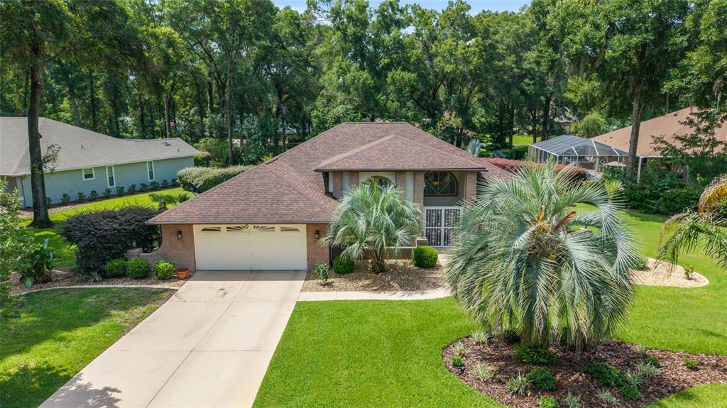 18825 Southwest 93rd Loop Dunnellon, FL 34432 - Photo 66 of 85 a front view of a house with a garden