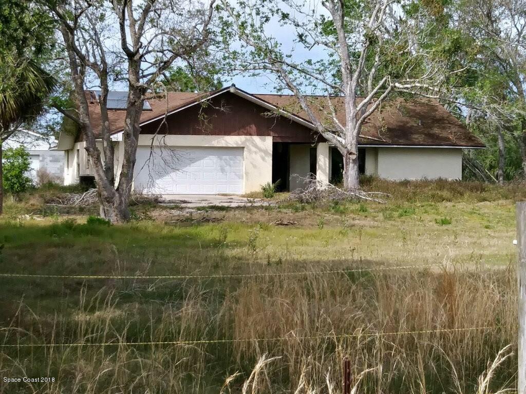 a house that has a tree in front of it