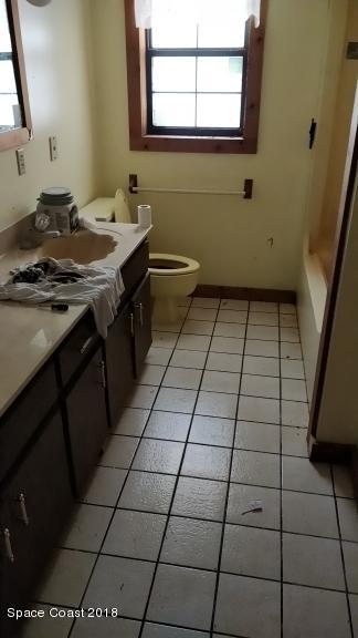 520 Atz Road Malabar, FL 32950 - Photo 12 of 15 a bathroom with a sink a toilet and a mirror