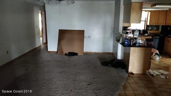 520 Atz Road Malabar, FL 32950 - Photo 6 of 15 a room with water heater and a wooden door