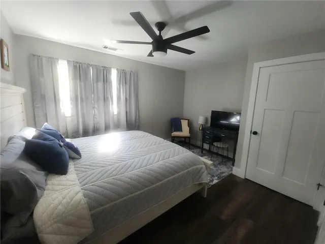 a bedroom with a bed and a chair