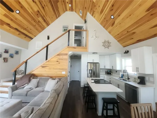 a kitchen with a table chairs sink and cabinets