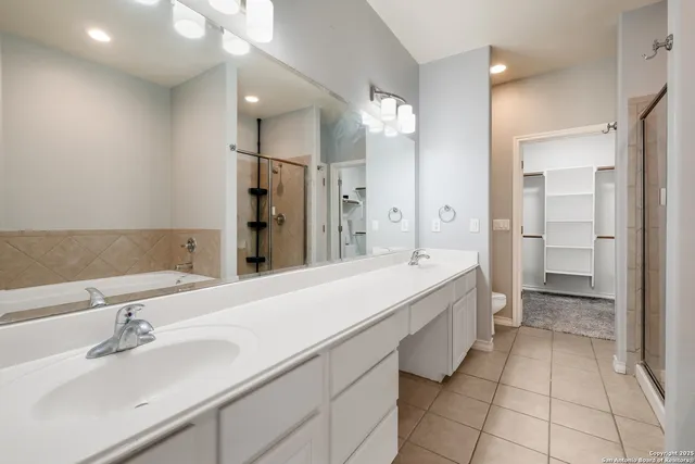 a spacious bathroom with a sink and a mirror
