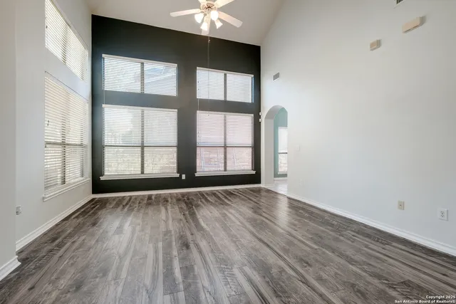 wooden floor in an empty room with a window