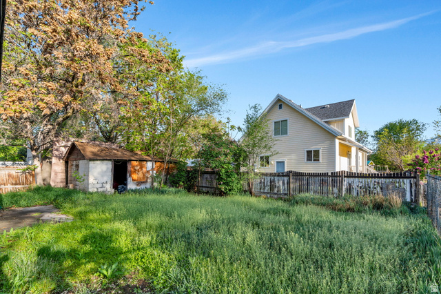 358 400 South Provo, UT 84601 - Photo 33 of 34 Rear view of house with a fenced backyard and a storage shed.