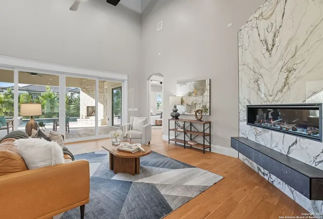 a living room with furniture large window and a table