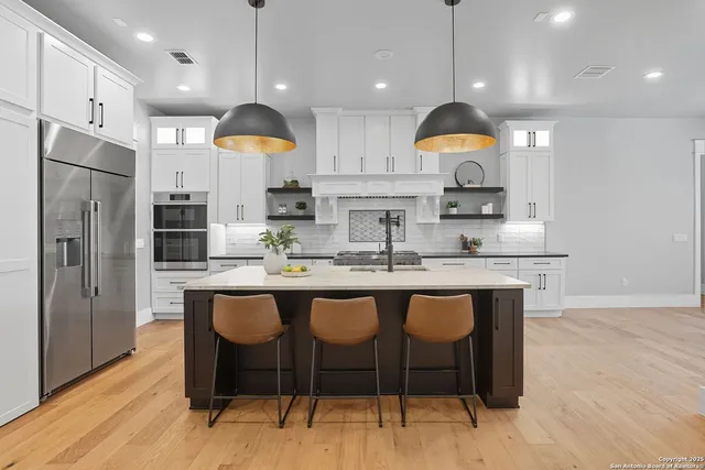 a kitchen with a sink cabinets and refrigerator