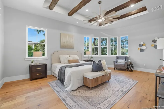 a spacious bedroom with a bed a couch and a dresser