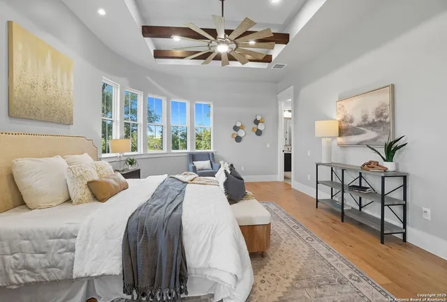a bedroom with double bed and a chandelier