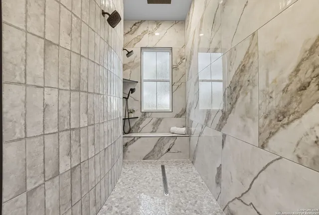 a bathroom with a bathtub and shower