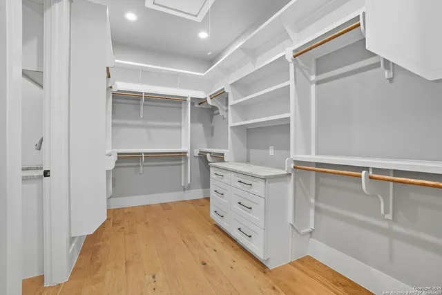 a room with white cabinets and a bed