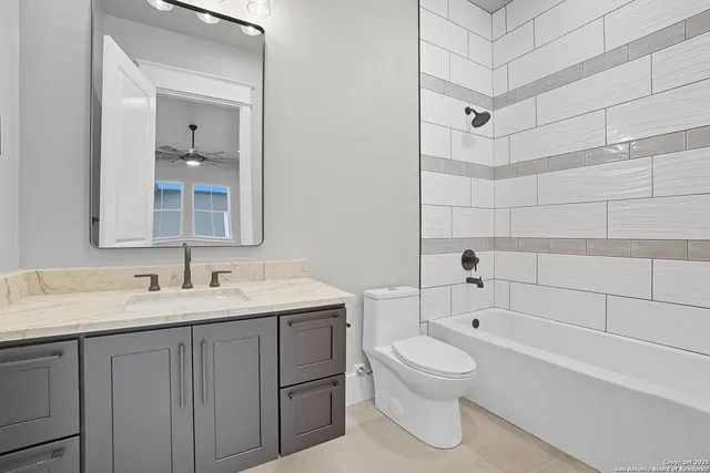 a bathroom with a toilet sink a mirror a bathtub and shower