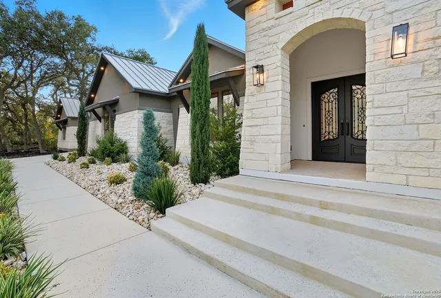 a front view of a house with garden