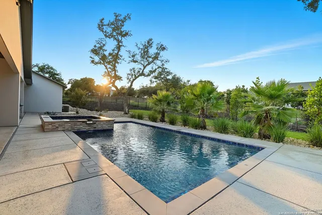 a view of a swimming pool with a yard