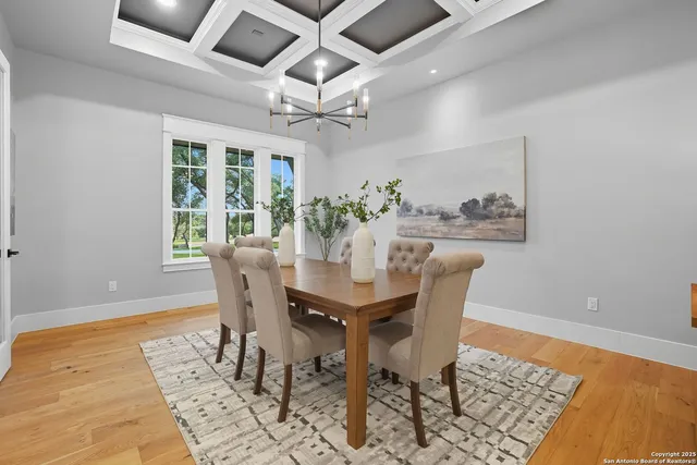 a dining room with furniture a rug and wooden floor