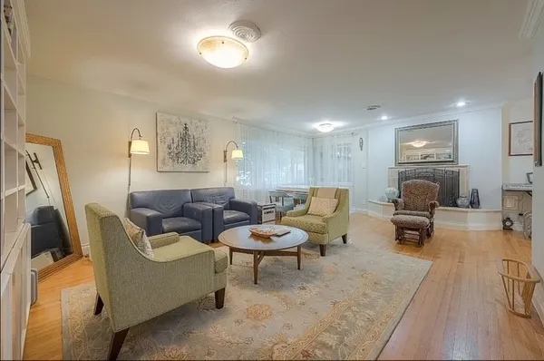 a living room with furniture and view of kitchen