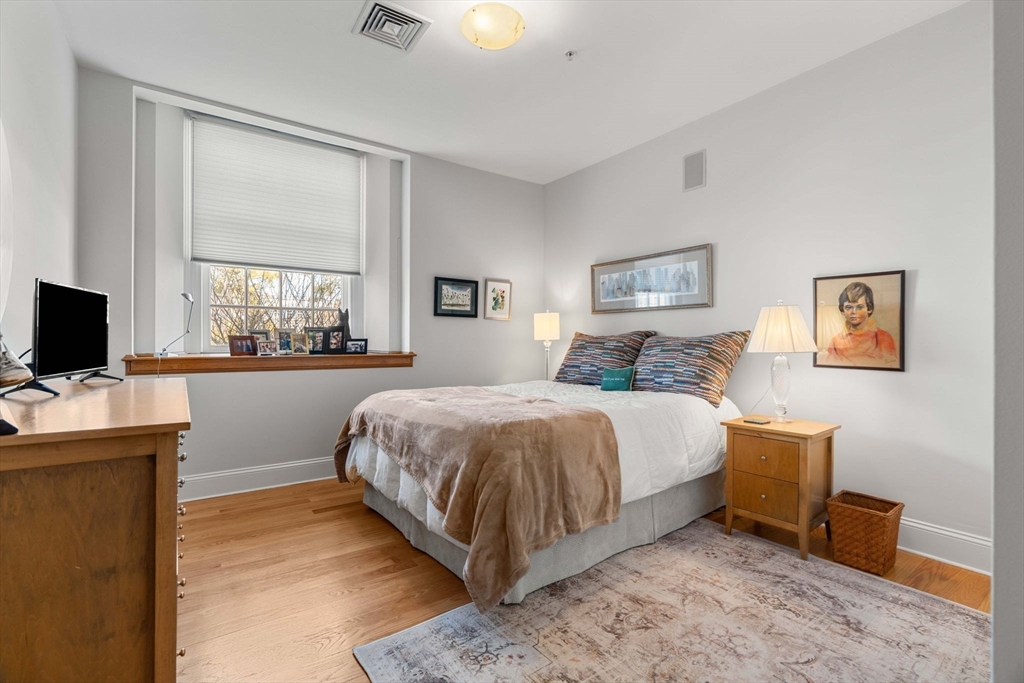 391 Walnut Street, Unit 4 Newton, MA 02460 - Photo 16 of 26 a bedroom with a bed and a flat screen tv