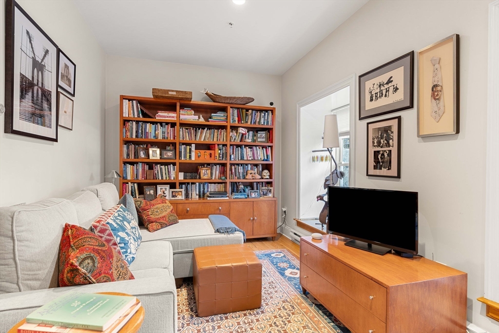 391 Walnut Street, Unit 4 Newton, MA 02460 - Photo 20 of 26 a living room with furniture workspace and a flat screen tv
