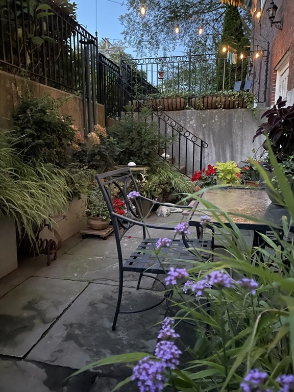 391 Walnut Street, Unit 4 Newton, MA 02460 - Photo 24 of 26 a view of a chairs and table in backyard