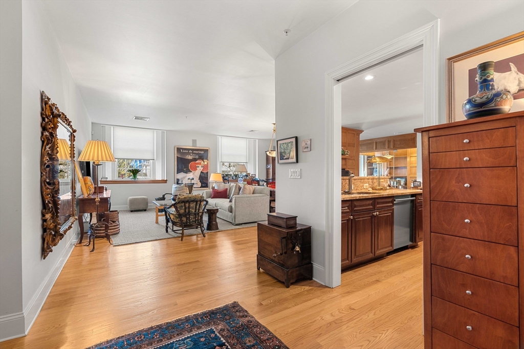 391 Walnut Street, Unit 4 Newton, MA 02460 - Photo 3 of 26 a living room with couches and kitchen view of it