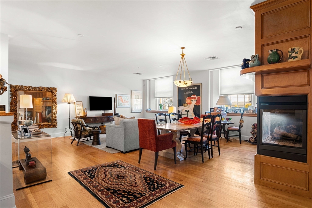 391 Walnut Street, Unit 4 Newton, MA 02460 - Photo 7 of 26 a living room with furniture flat screen tv and a fireplace