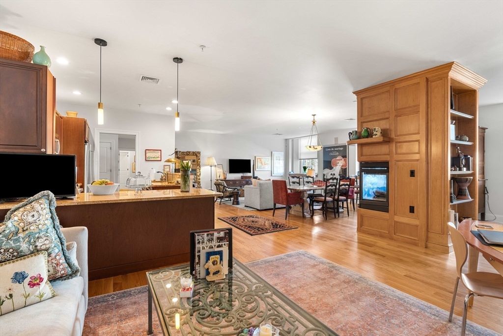391 Walnut Street, Unit 4 Newton, MA 02460 - Photo 10 of 26 a living room with lots of furniture and a chandelier