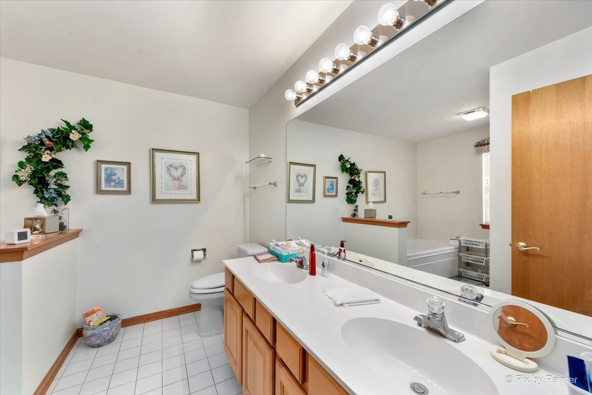 13412 Tall Pines Lane Plainfield, IL 60544 - Photo 12 of 19 a bathroom with a sink a large mirror and a shower