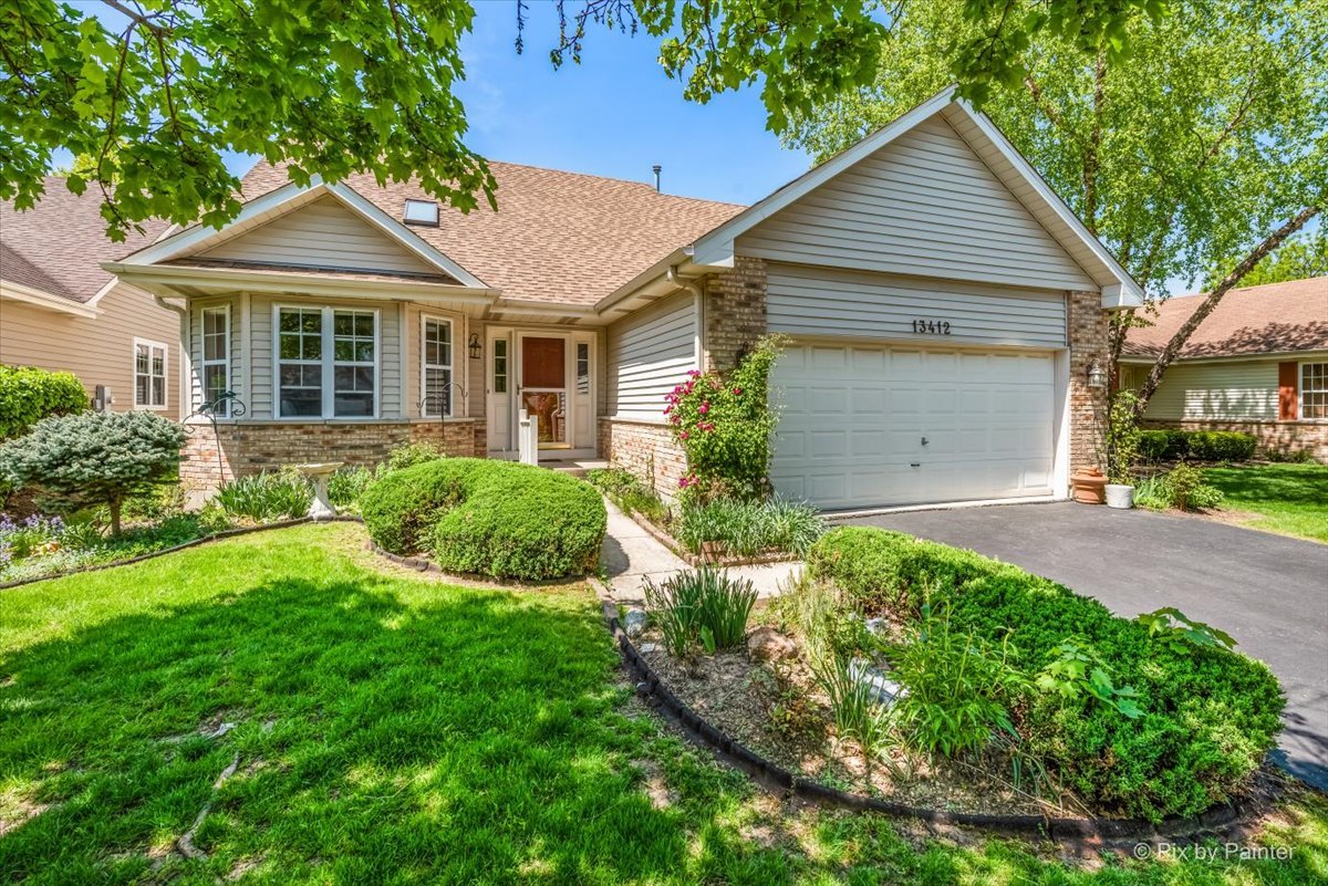 13412 Tall Pines Lane Plainfield, IL 60544 - Photo 18 of 19 a front view of a house with a yard and garage
