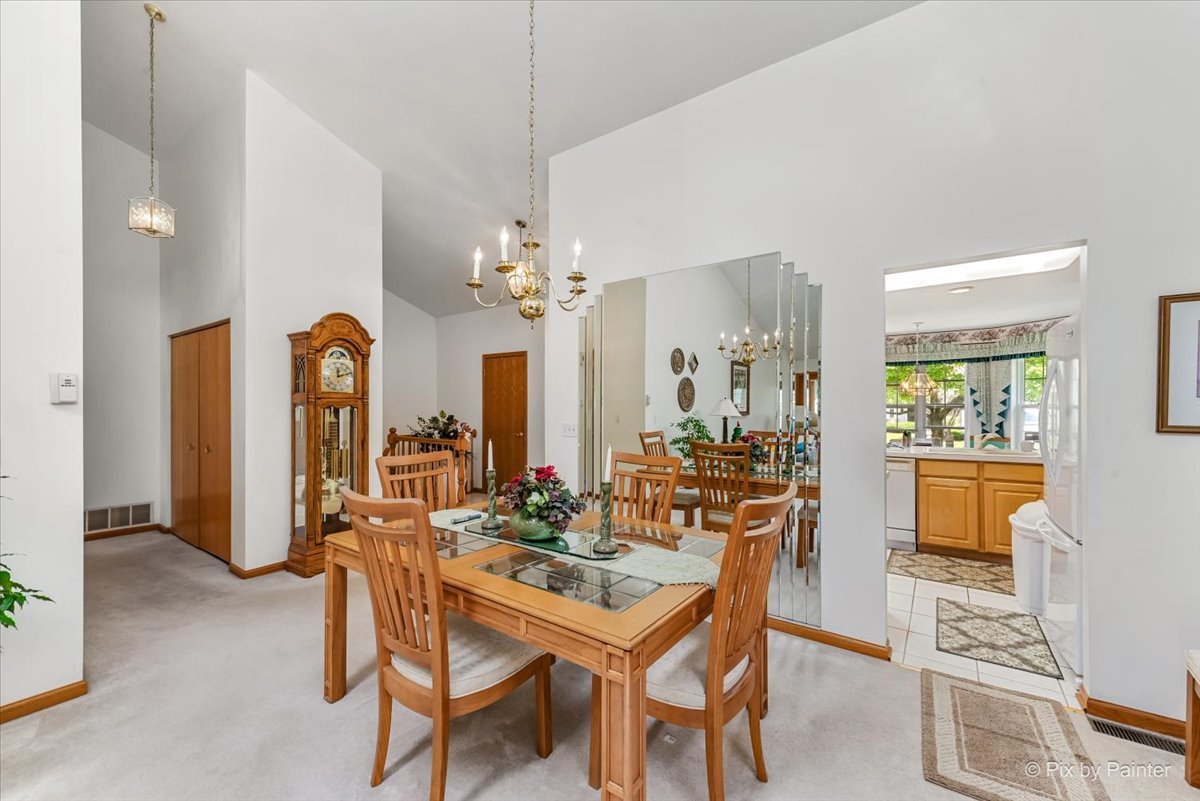 13412 Tall Pines Lane Plainfield, IL 60544 - Photo 6 of 19 a view of a dining room with furniture and a chandelier