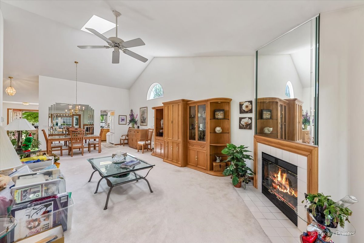 13412 Tall Pines Lane Plainfield, IL 60544 - Photo 8 of 19 a living room with furniture a fireplace and a chandelier