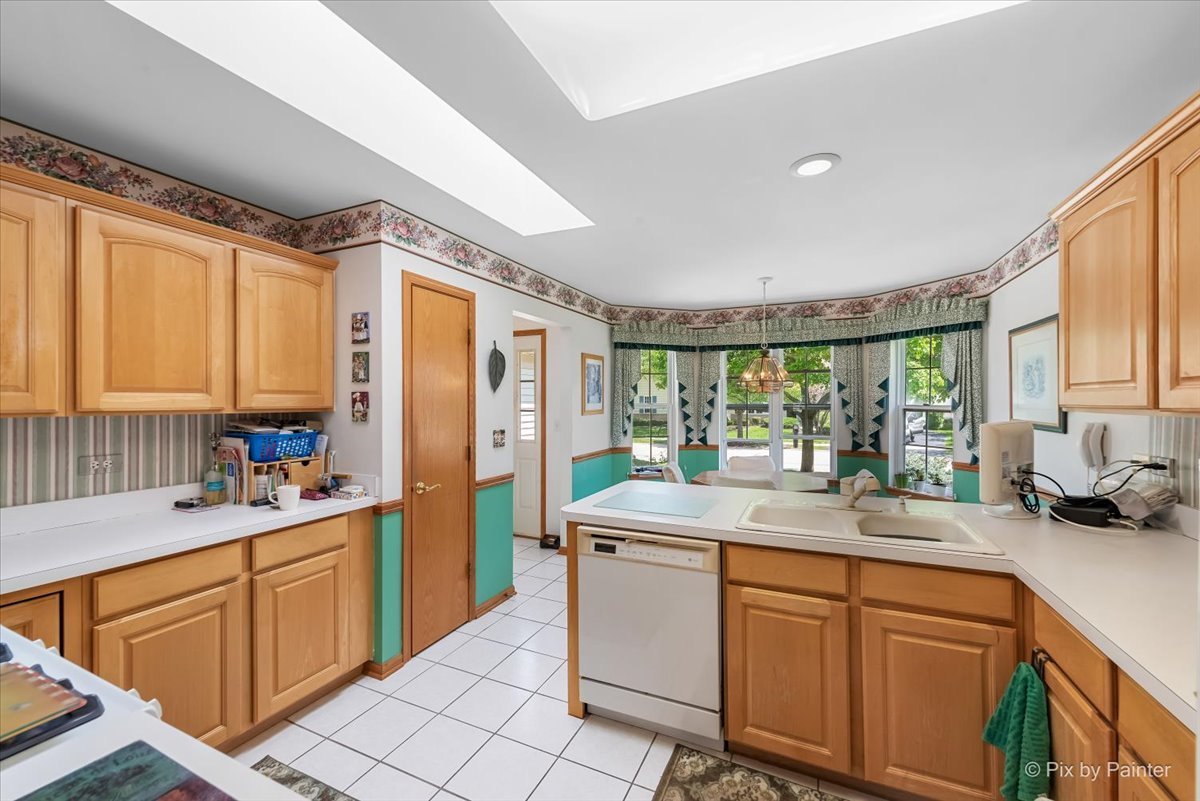 13412 Tall Pines Lane Plainfield, IL 60544 - Photo 9 of 19 a kitchen with sink a window and cabinets