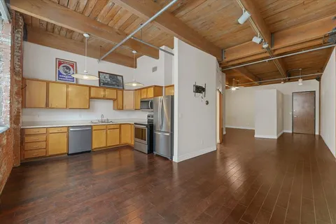 a kitchen with stainless steel appliances granite countertop a refrigerator and a stove top oven