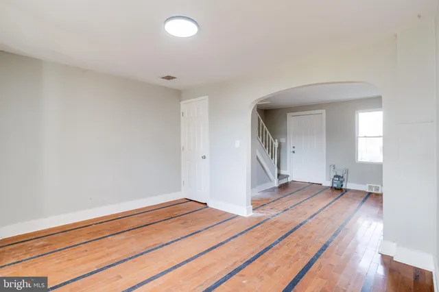 a view of a room with wooden floor and bathroom