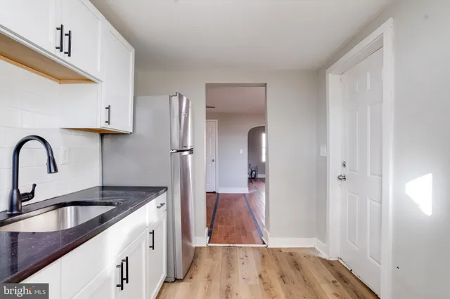 a kitchen with a refrigerator and a sink