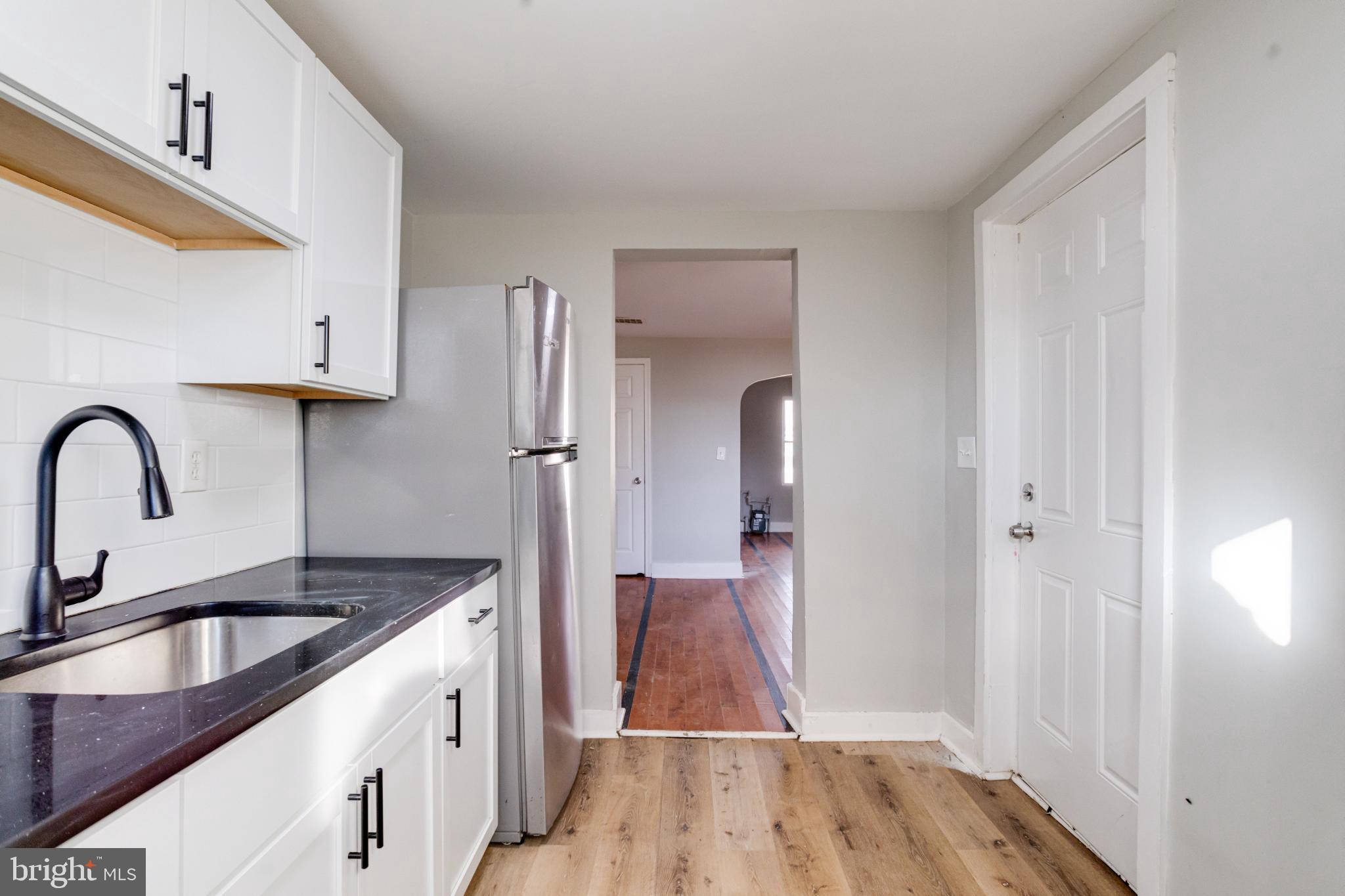 6573 St Helena Avenue Baltimore, MD 21222 - Photo 18 of 37 a kitchen with a refrigerator and a sink
