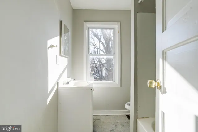 a bathroom with a window and a shower