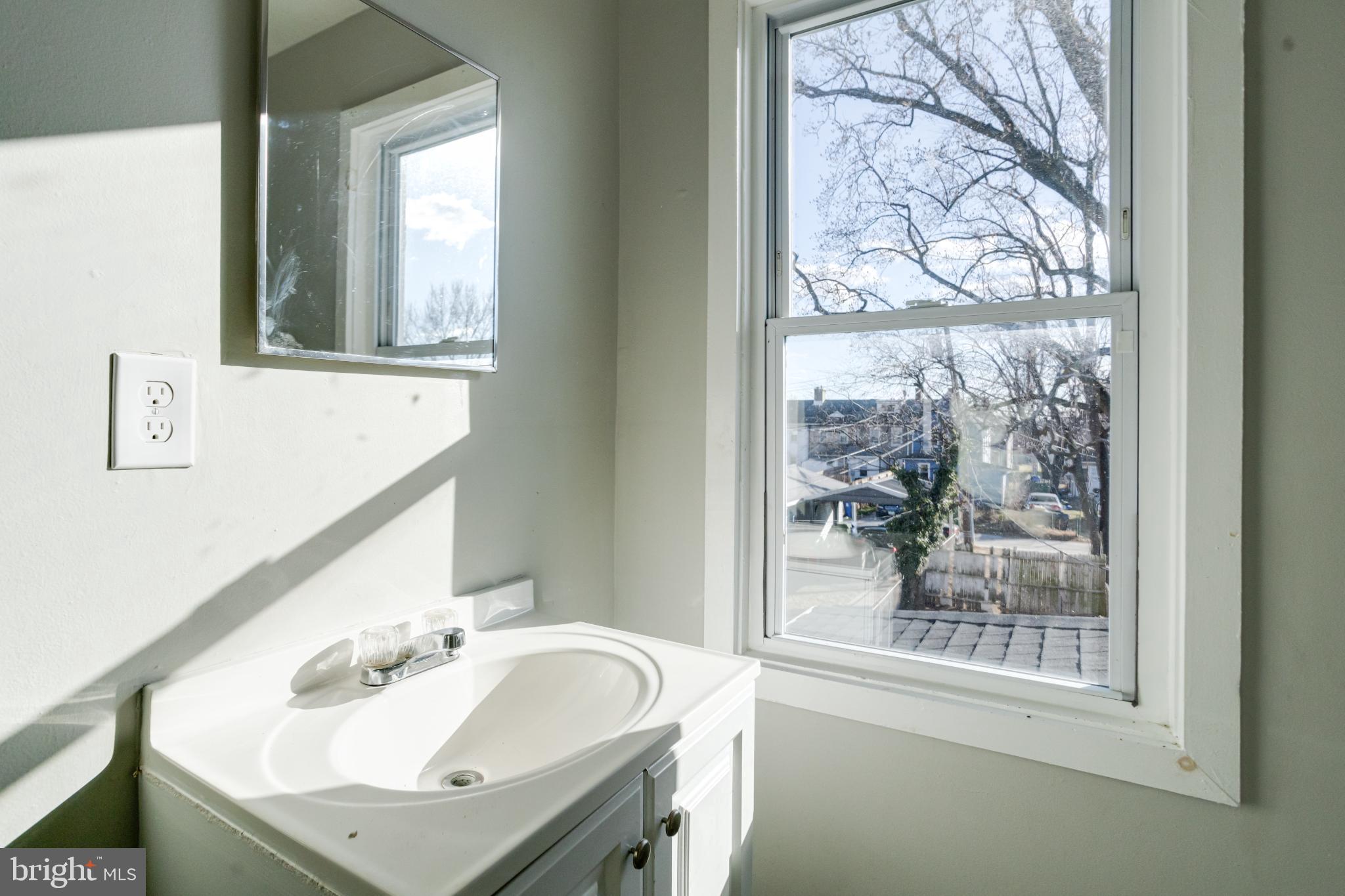 6573 St Helena Avenue Baltimore, MD 21222 - Photo 31 of 37 a bathroom with a sink and a mirror