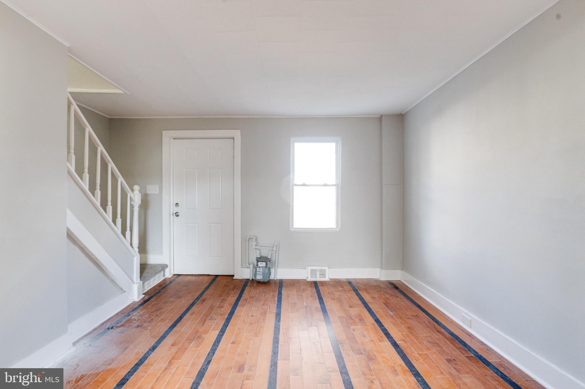 6573 St Helena Avenue Baltimore, MD 21222 - Photo 8 of 37 a view of a room with wooden floor and staircase