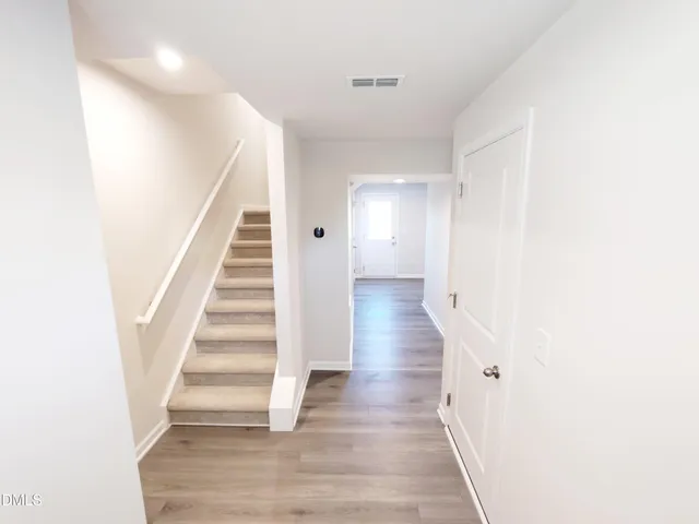 a view of a hallway with wooden floor