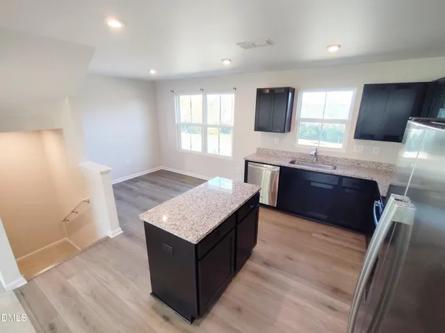 a kitchen with a sink and a mirror