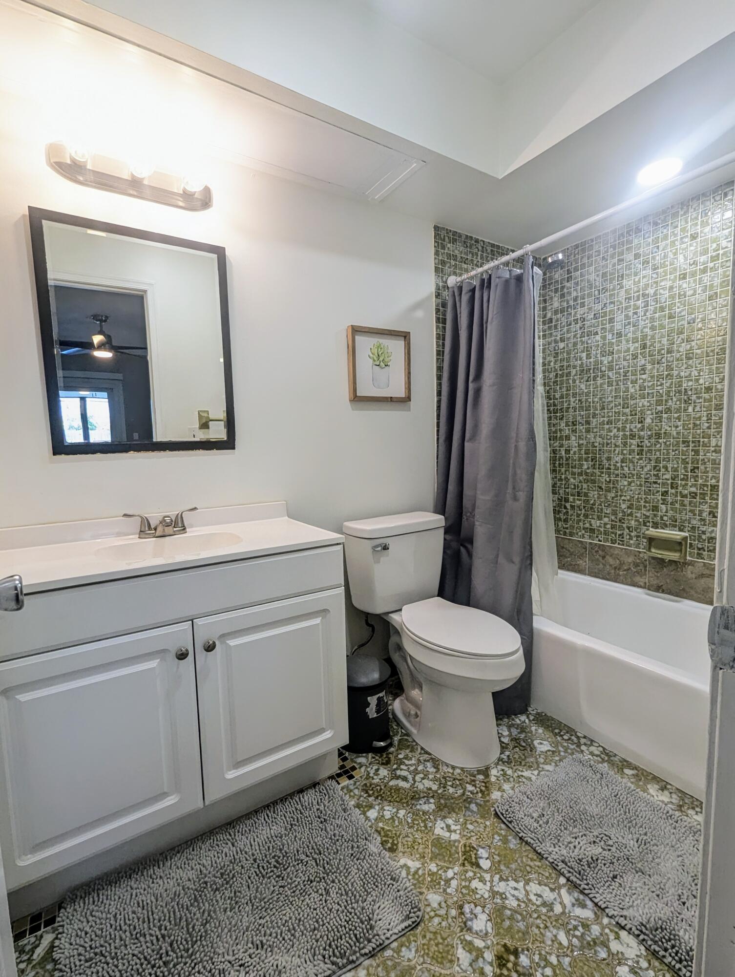 1350 Riverside Circle, Unit S A AND B Wellington, FL 33414 - Photo 16 of 67 a bathroom with a toilet a sink and a mirror