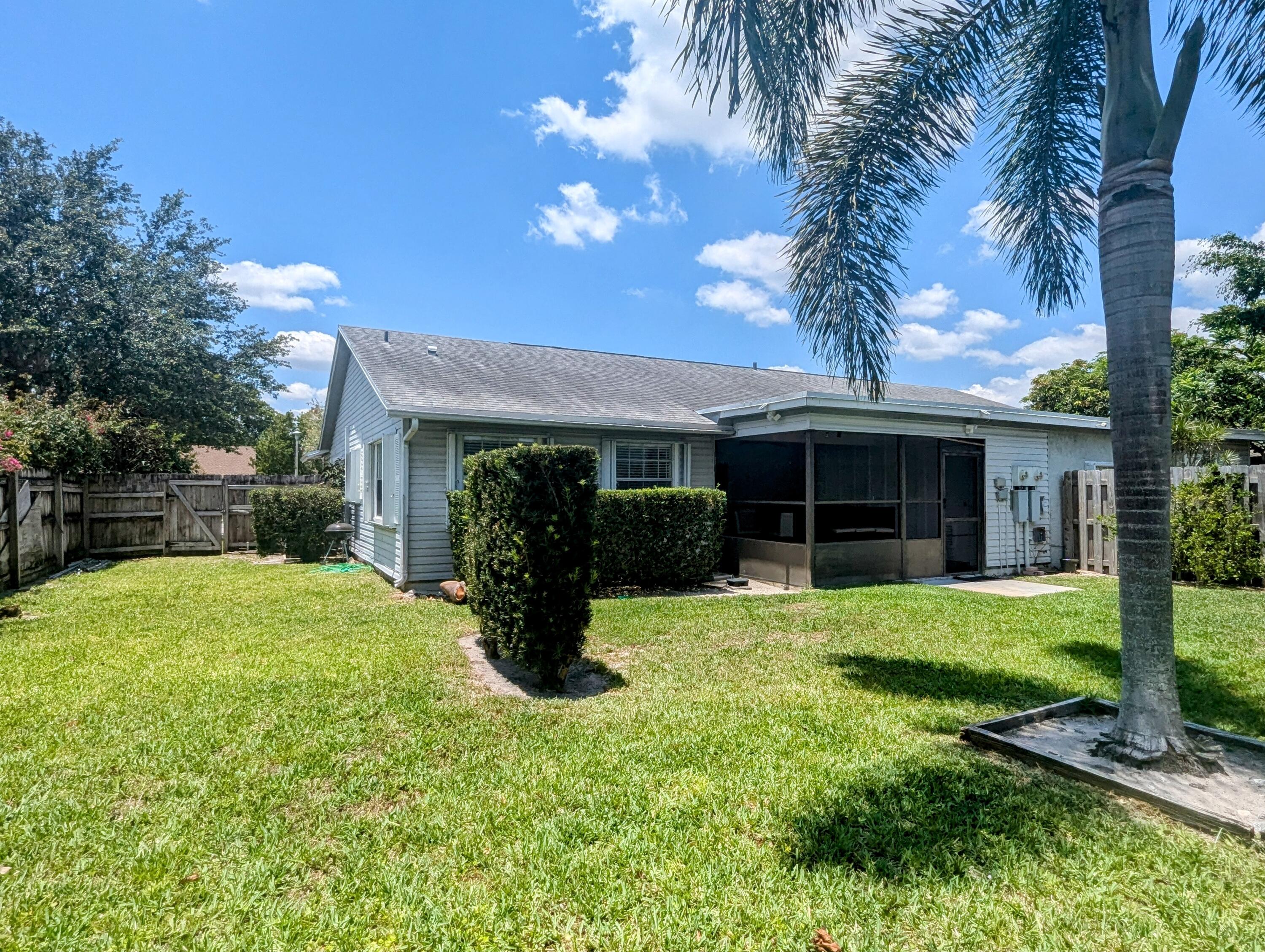 1350 Riverside Circle, Unit S A AND B Wellington, FL 33414 - Photo 33 of 67 a view of a house with a yard and potted plants