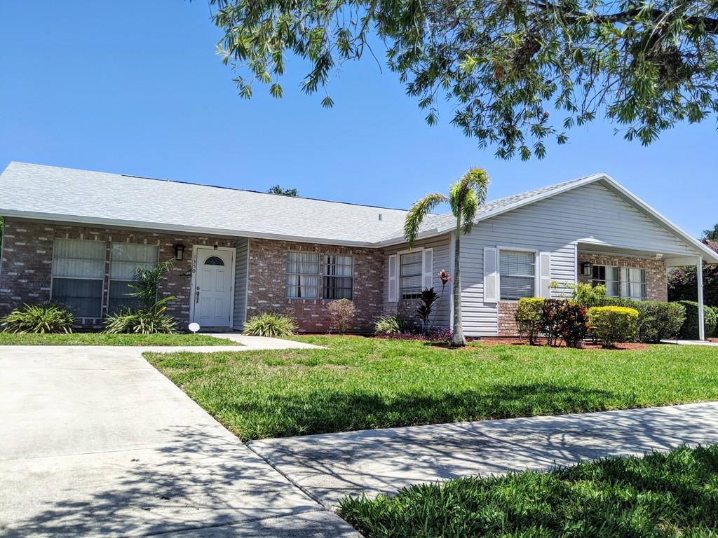 1350 Riverside Circle, Unit S A AND B Wellington, FL 33414 - Photo 37 of 67 a front view of a house with a garden and yard