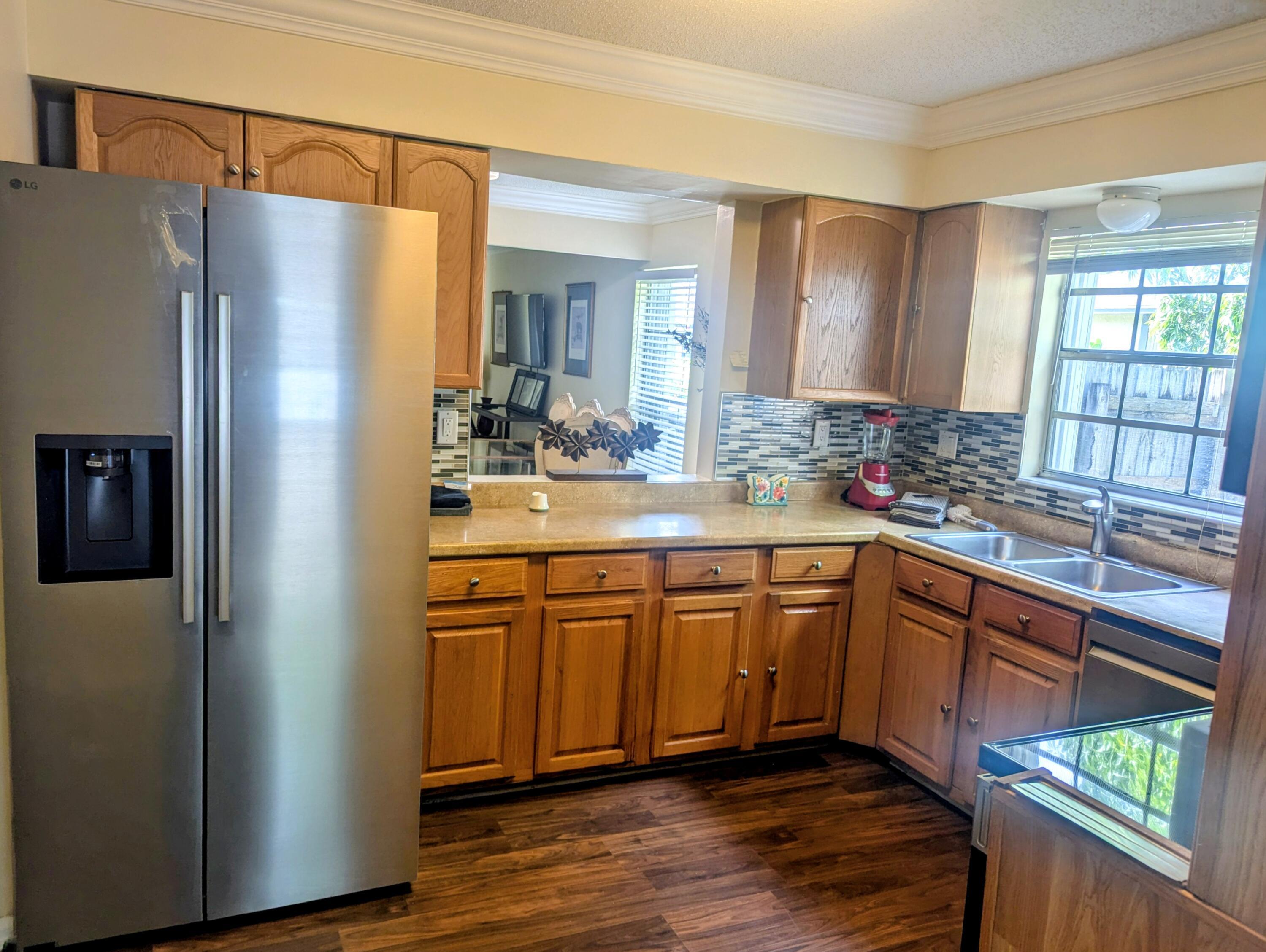1350 Riverside Circle, Unit S A AND B Wellington, FL 33414 - Photo 47 of 67 a kitchen with stainless steel appliances granite countertop a refrigerator and a sink