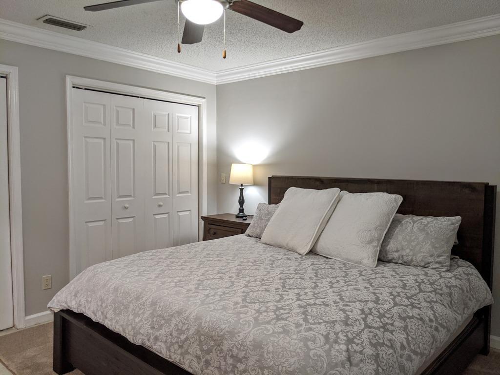 1350 Riverside Circle, Unit S A AND B Wellington, FL 33414 - Photo 50 of 67 a bedroom with a bed and a lamp on the dresser