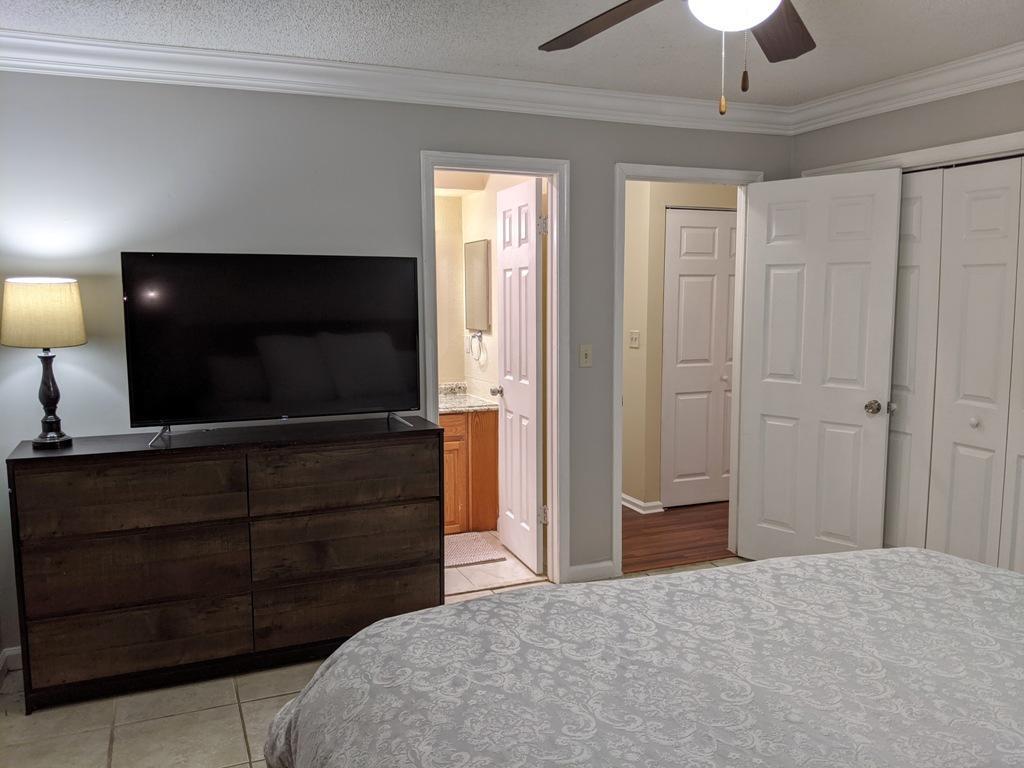 1350 Riverside Circle, Unit S A AND B Wellington, FL 33414 - Photo 51 of 67 a bedroom with a bed and a flat tv screen on dresser