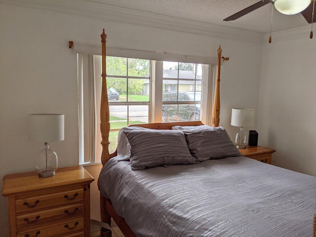 1350 Riverside Circle, Unit S A AND B Wellington, FL 33414 - Photo 58 of 67 a bedroom with a bed and a window