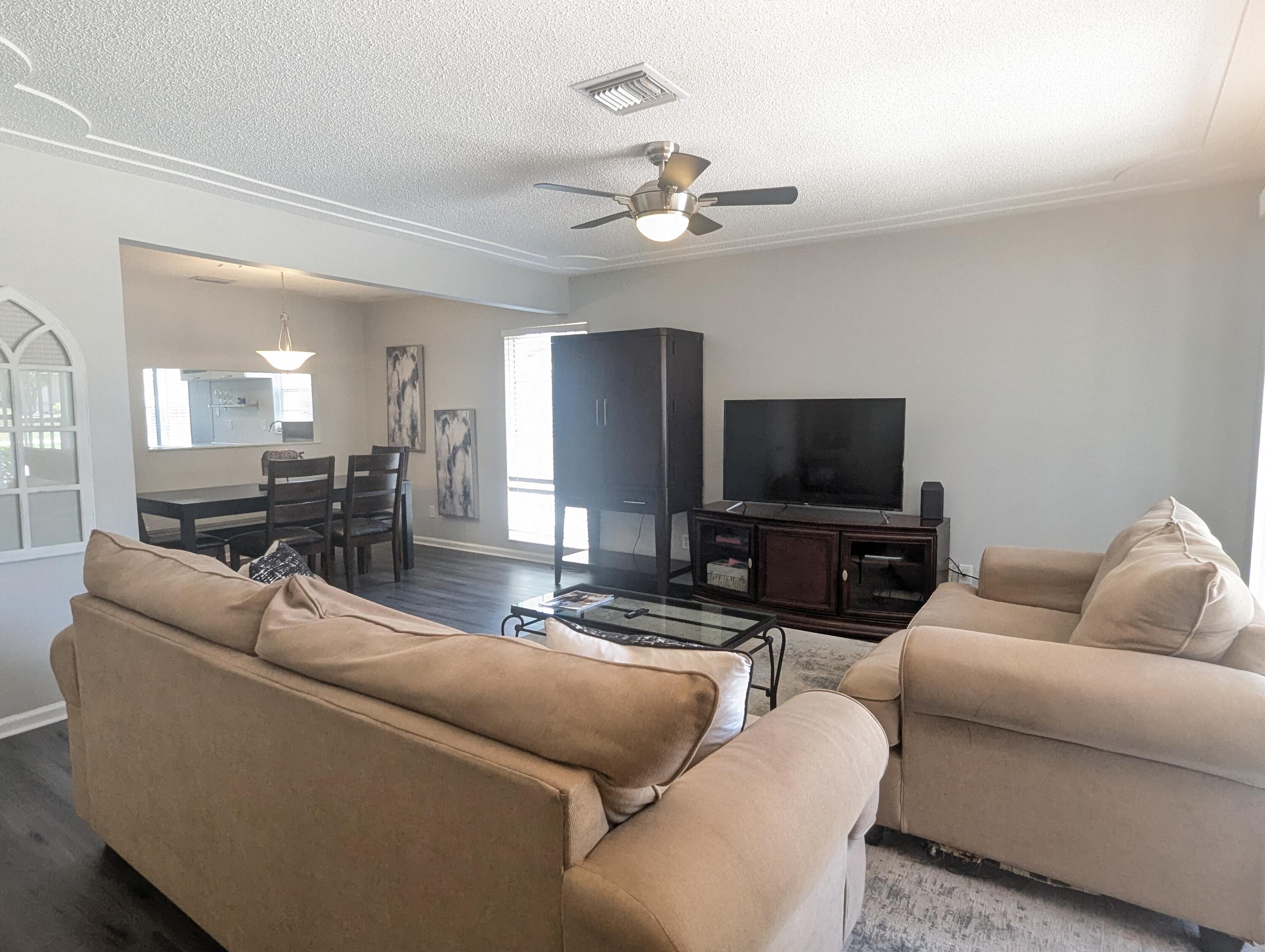 1350 Riverside Circle, Unit S A AND B Wellington, FL 33414 - Photo 6 of 67 a living room with furniture and a flat screen tv
