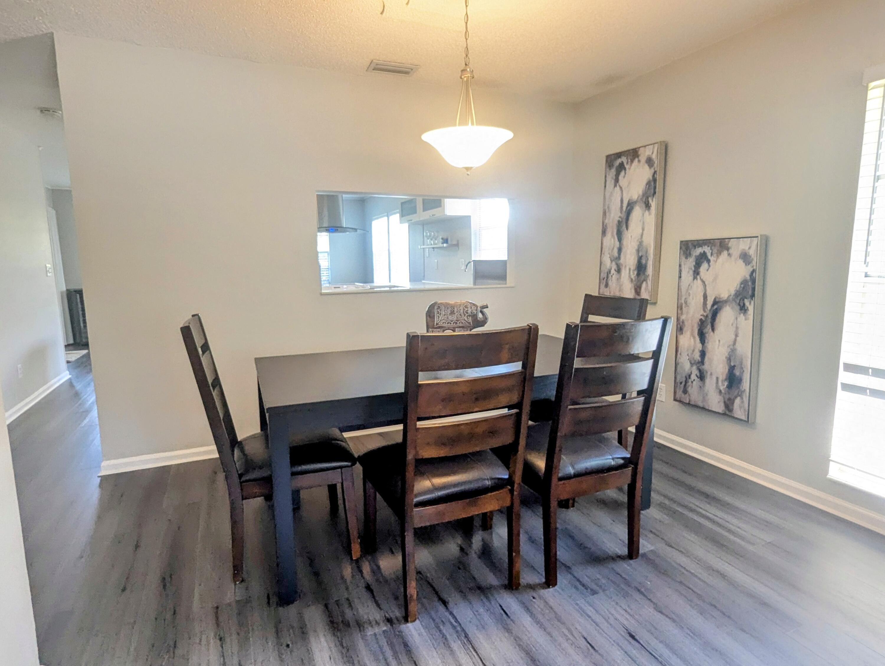 1350 Riverside Circle, Unit S A AND B Wellington, FL 33414 - Photo 10 of 67 a view of a dining room with furniture and wooden floor