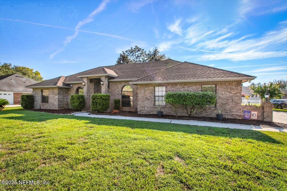 a view of a house with swimming pool and a yard